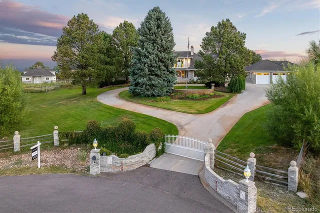 a view of a house with a yard and a garden