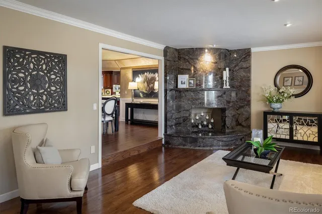 a living room with fireplace furniture and kitchen view