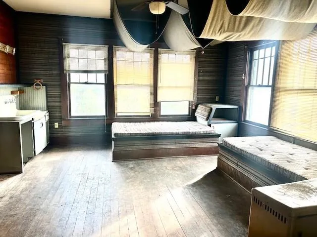 a living room with furniture and two window