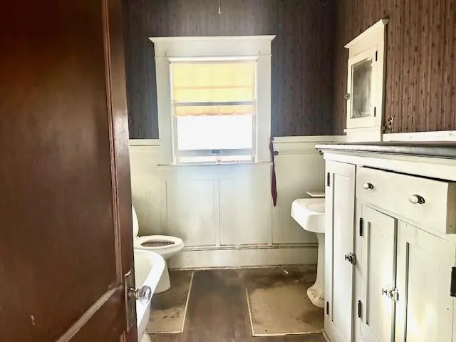 a bathroom with a granite countertop toilet sink and a mirror