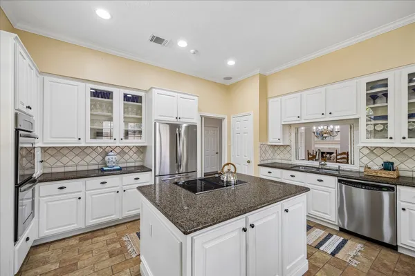 a kitchen with stainless steel appliances granite countertop a sink stove and refrigerator