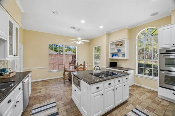 a kitchen with refrigerator cabinets and sink