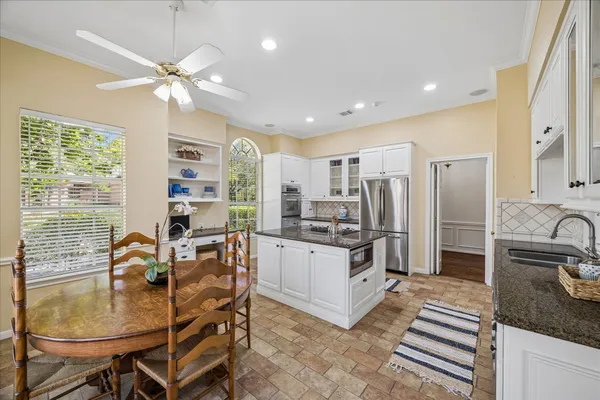 a dining room with furniture a rug and wooden floor