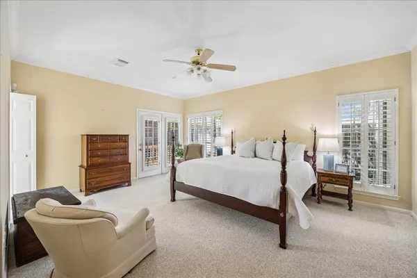 a spacious bedroom with a bed and a couch