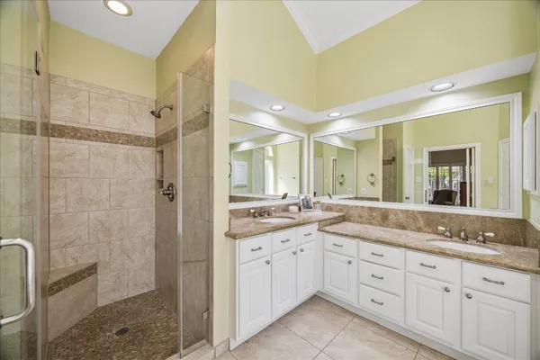 a spacious bathroom with a granite countertop sink mirror and shower