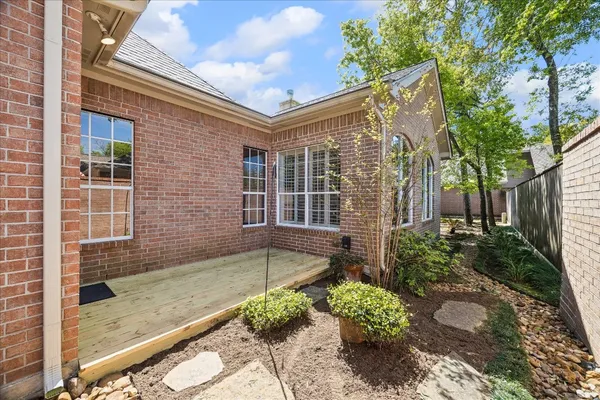 a view of a brick house with a yard