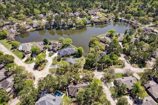 an aerial view of city and lake with boats