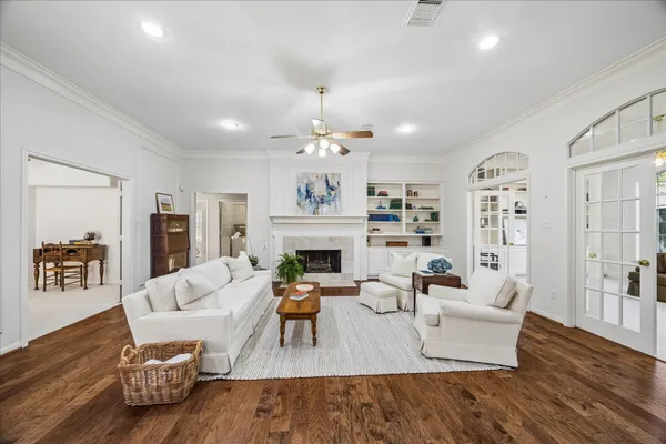 a living room with furniture fireplace and wooden floor