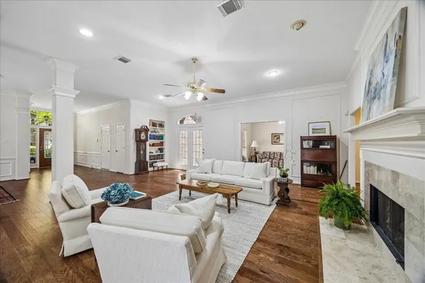 a living room with furniture fireplace and a chandelier