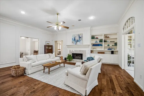a living room with furniture a fireplace and a chandelier