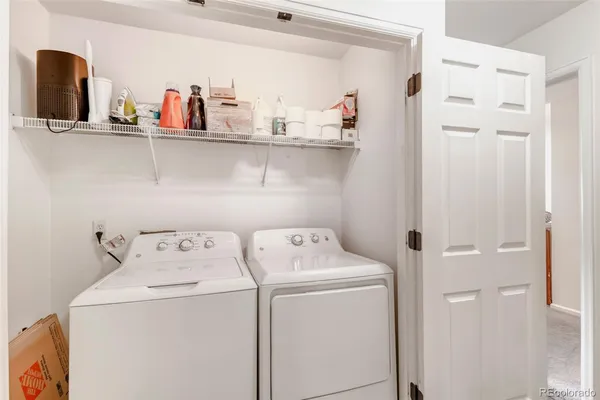 a view of storage and utility room with washer and dryer