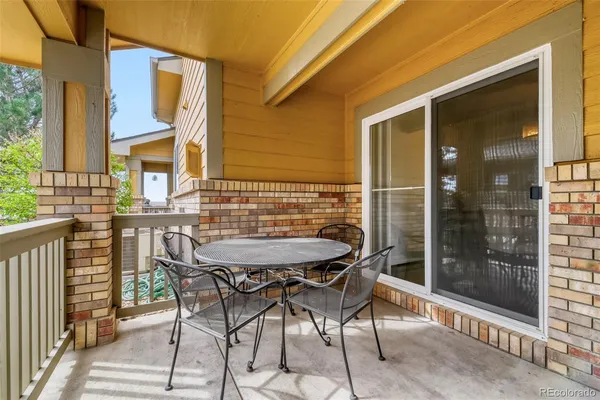 a view of a patio with table and chairs