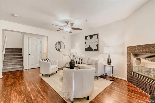 a living room with furniture and wooden floor