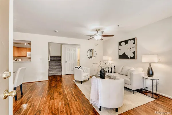 a living room with furniture and wooden floor