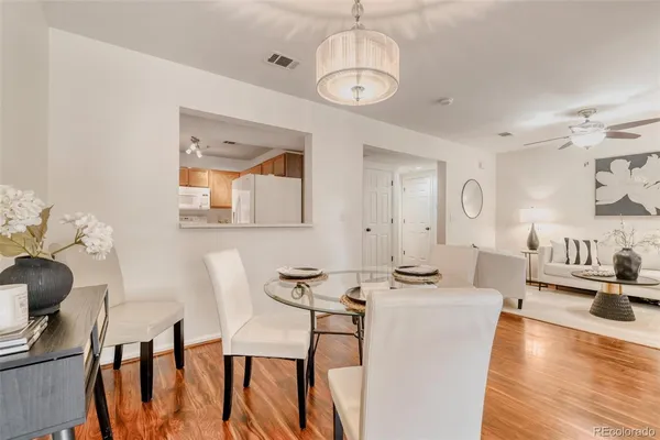 a view of a dining room with furniture a chandelier and wooden floor