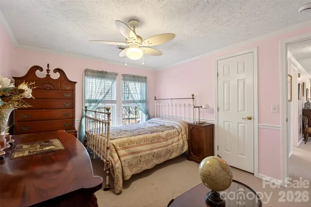 a bedroom with a bed and a dresser in it