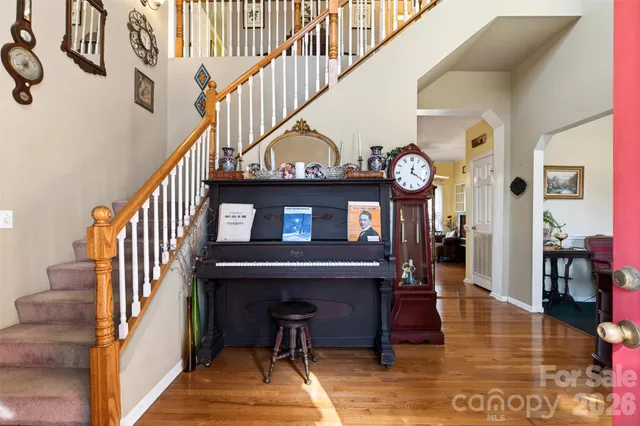 a view of entryway livingroom and hall with wooden floor