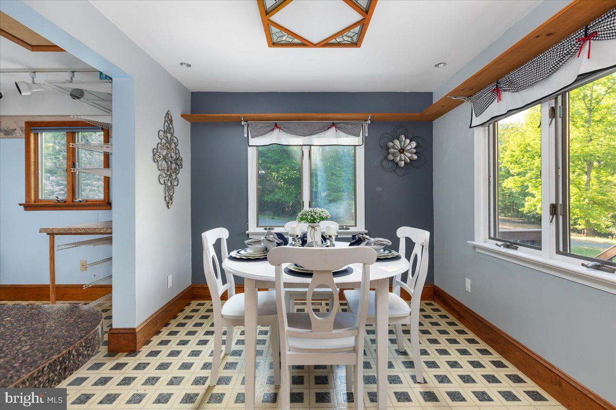 146 Lizzie Mills Road Castleton, VA 22716 - Photo 12 of 91 a dining room with furniture a chandelier and wooden floor