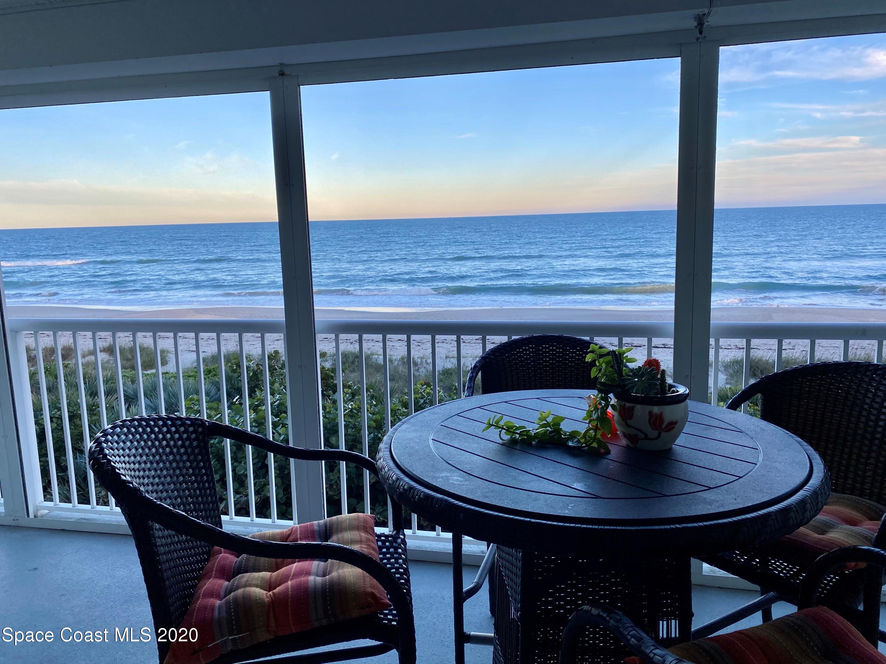 a view of a balcony with table and chairs