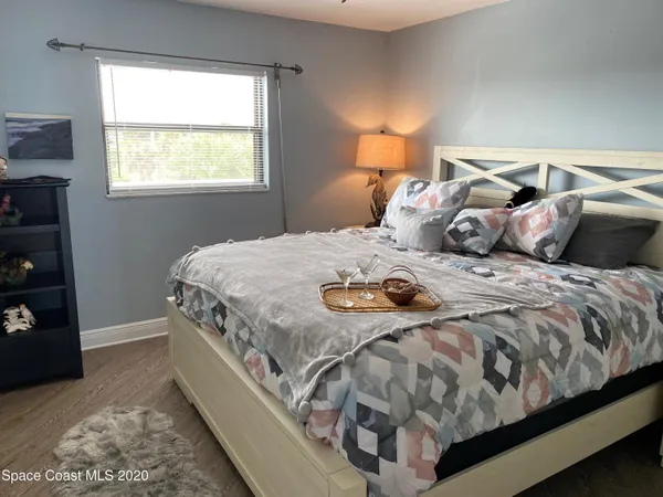 a bedroom with bed and a flat screen tv