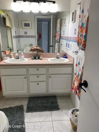 a bathroom with a toilet a sink and a mirror
