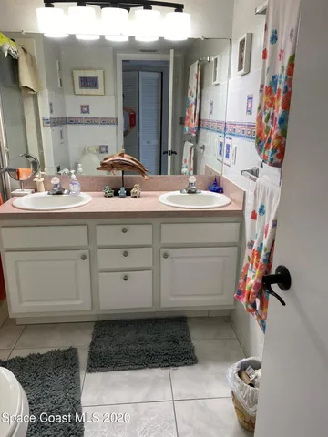 a bathroom with a toilet a sink and a mirror