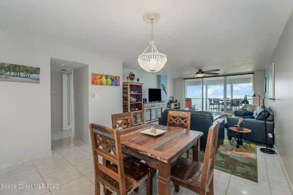 a living room with furniture a flat screen tv and kitchen view