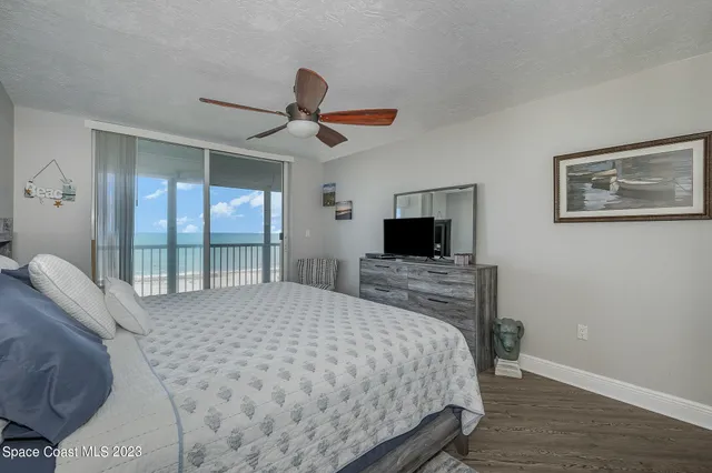 a bedroom with a bed and a ceiling fan