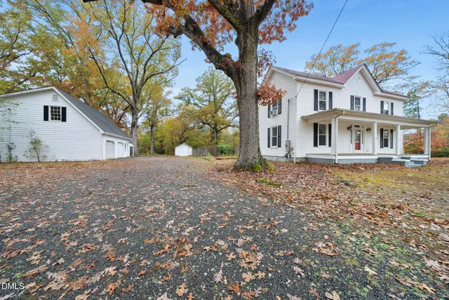 a picture of a room with a white wall and a painting