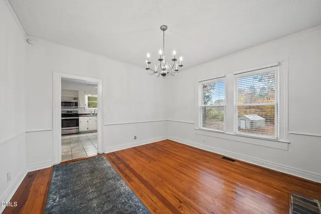a kitchen with granite countertop white cabinets and appliances