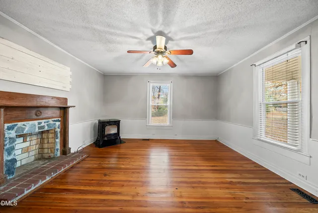 wooden floor in an empty room with a window