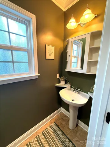 a bathroom with a sink toilet and mirror