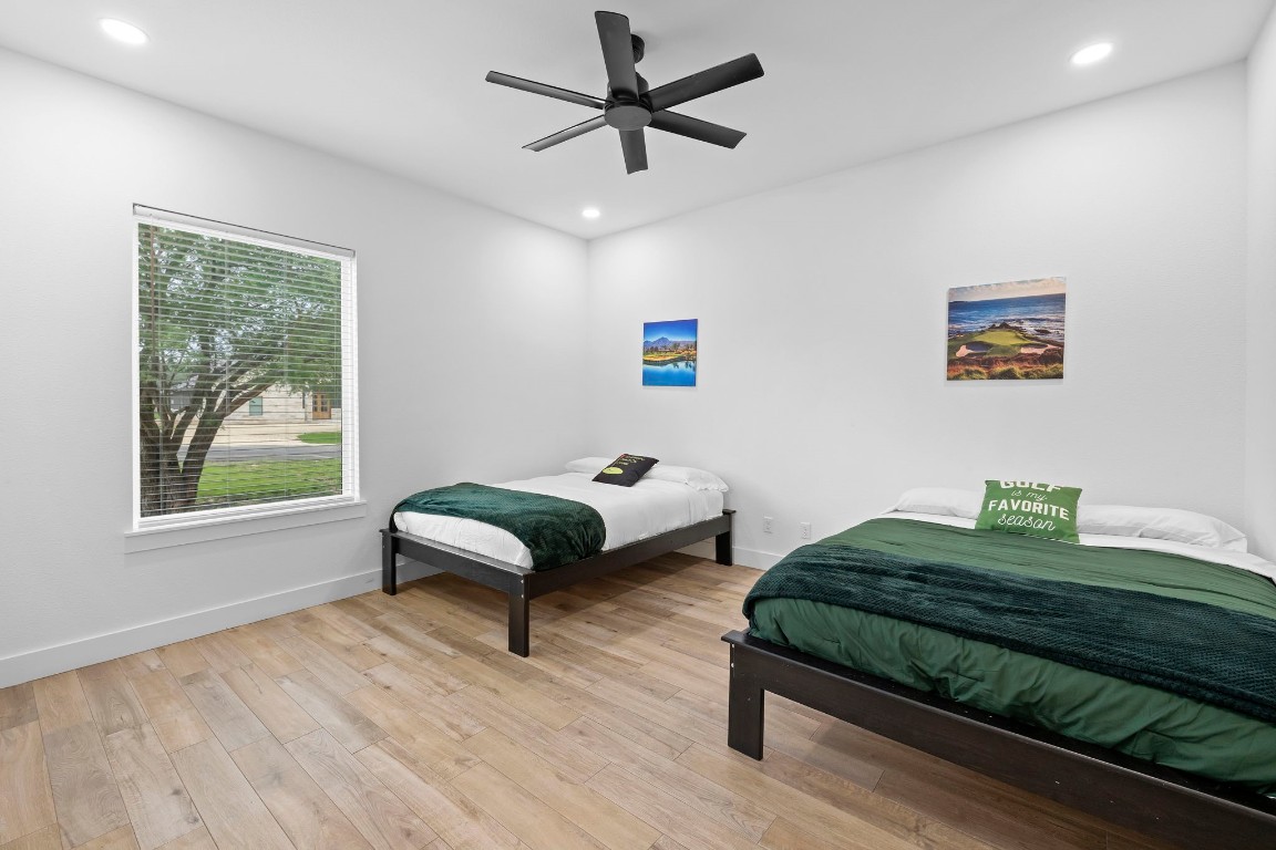 1463 Mountain Valley Road Concan, TX 78838 - Photo 13 of 43 a bedroom with a bed and a large window