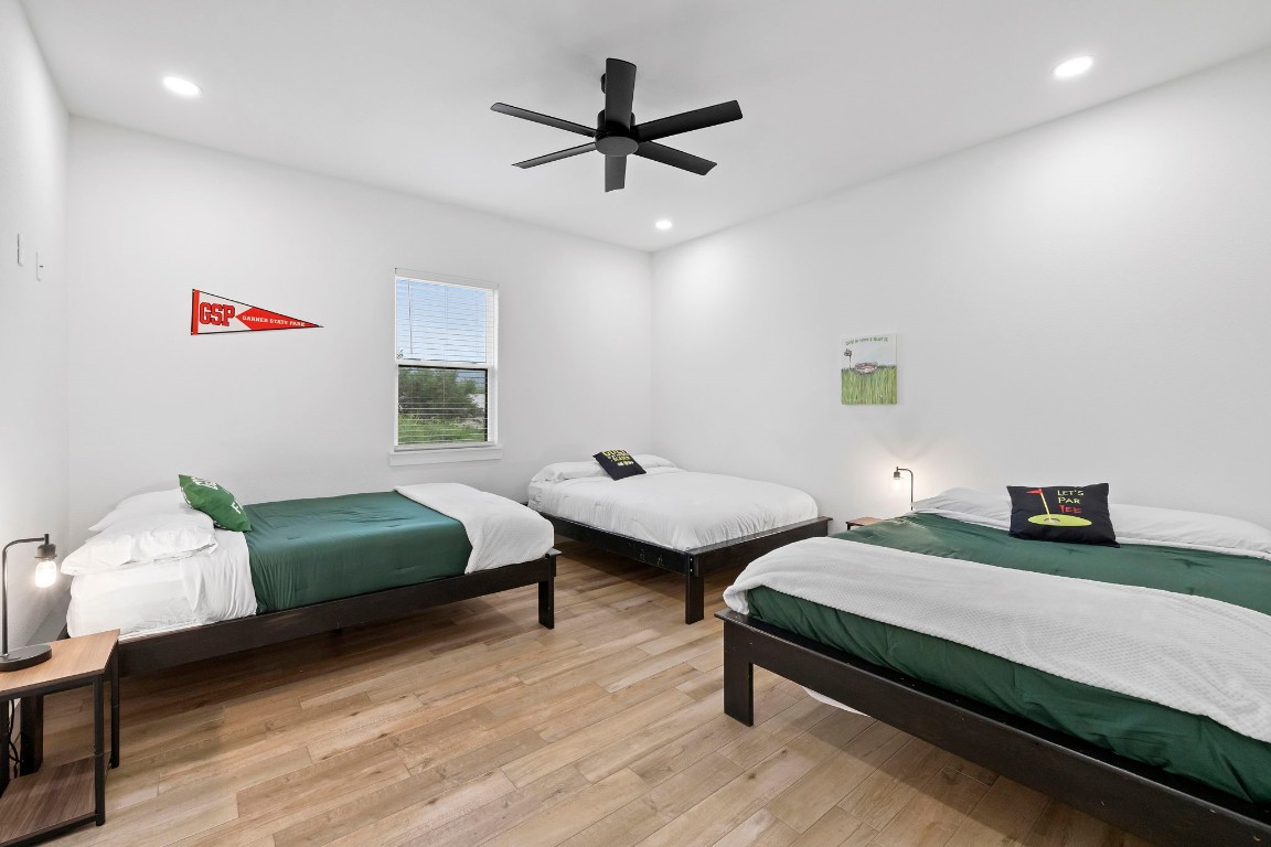 1463 Mountain Valley Road Concan, TX 78838 - Photo 15 of 43 a bedroom with two beds and a chandelier