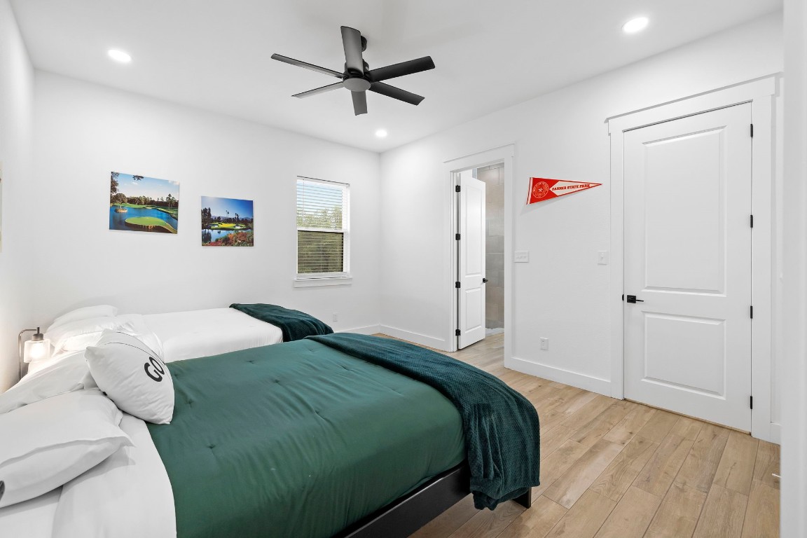 1463 Mountain Valley Road Concan, TX 78838 - Photo 16 of 43 a bedroom with a bed and a chandelier