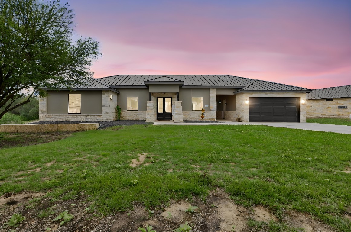 1463 Mountain Valley Road Concan, TX 78838 - Photo 2 of 43 a front view of a house with a yard and trees