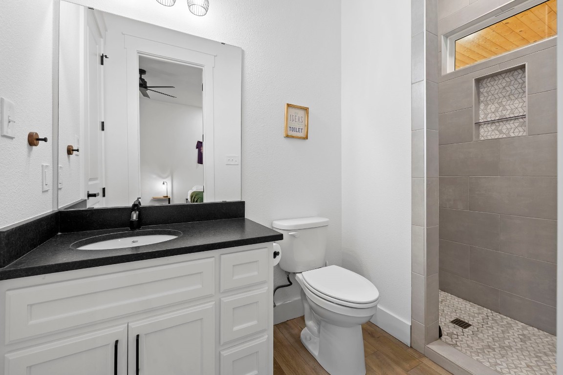 1463 Mountain Valley Road Concan, TX 78838 - Photo 21 of 43 a bathroom with a granite countertop sink and a toilet