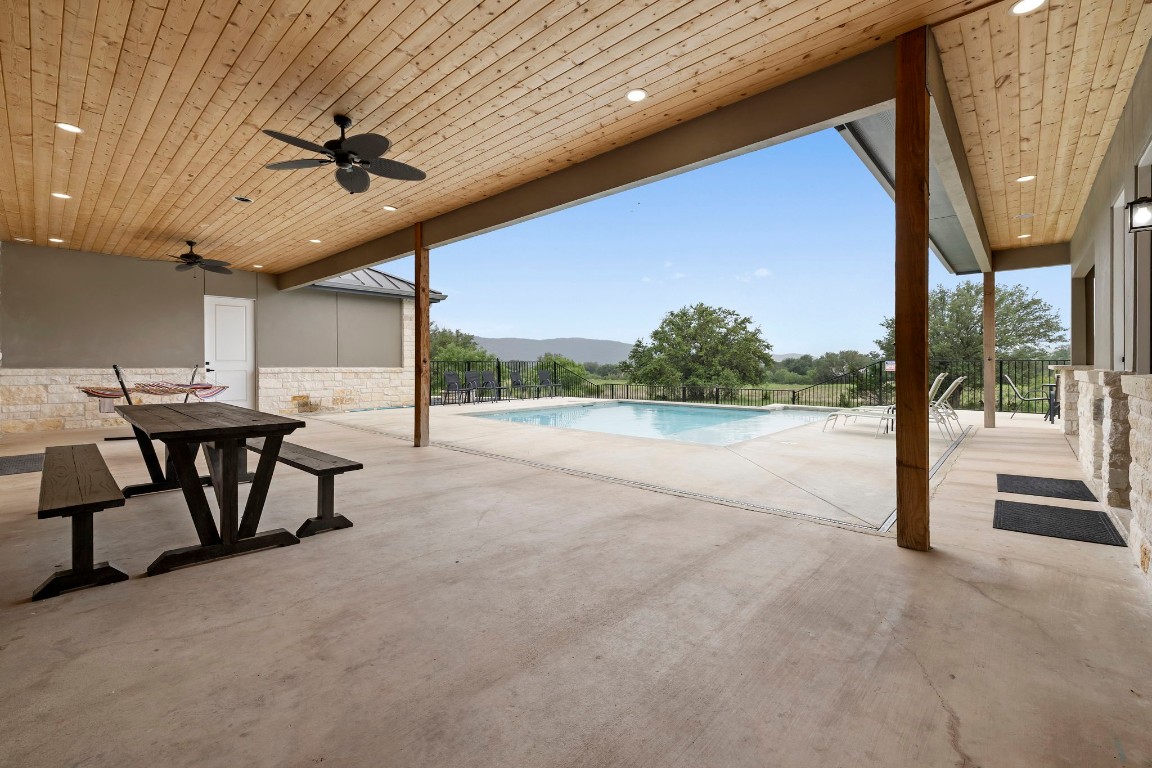 1463 Mountain Valley Road Concan, TX 78838 - Photo 27 of 43 a view of a porch with furniture and a floor to ceiling window