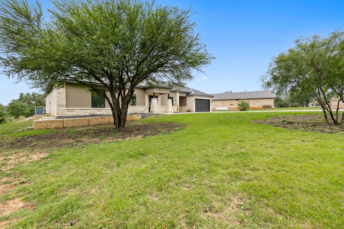 1463 Mountain Valley Road Concan, TX 78838 - Photo 3 of 43 a house with garden in front of it