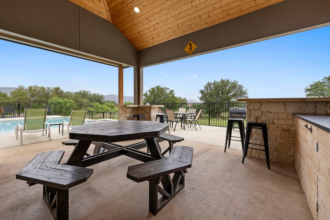 1463 Mountain Valley Road Concan, TX 78838 - Photo 31 of 43 a view of a tables and chairs on the roof deck