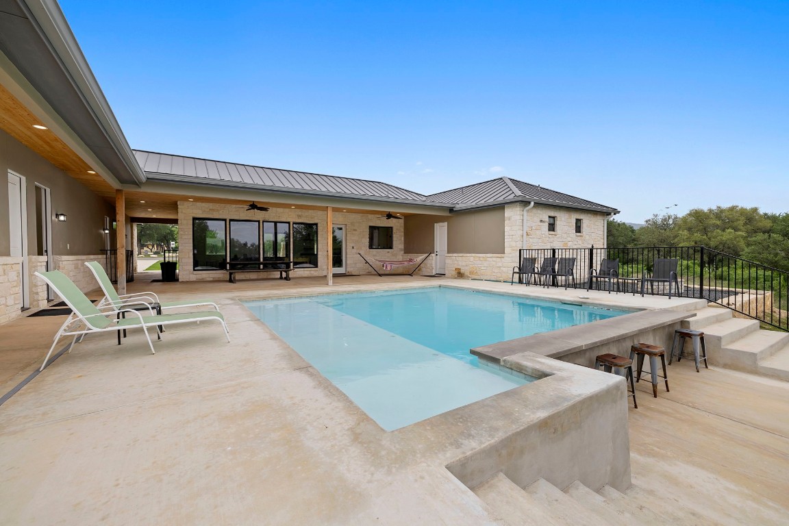 1463 Mountain Valley Road Concan, TX 78838 - Photo 33 of 43 a view of a house with swimming pool and sitting area