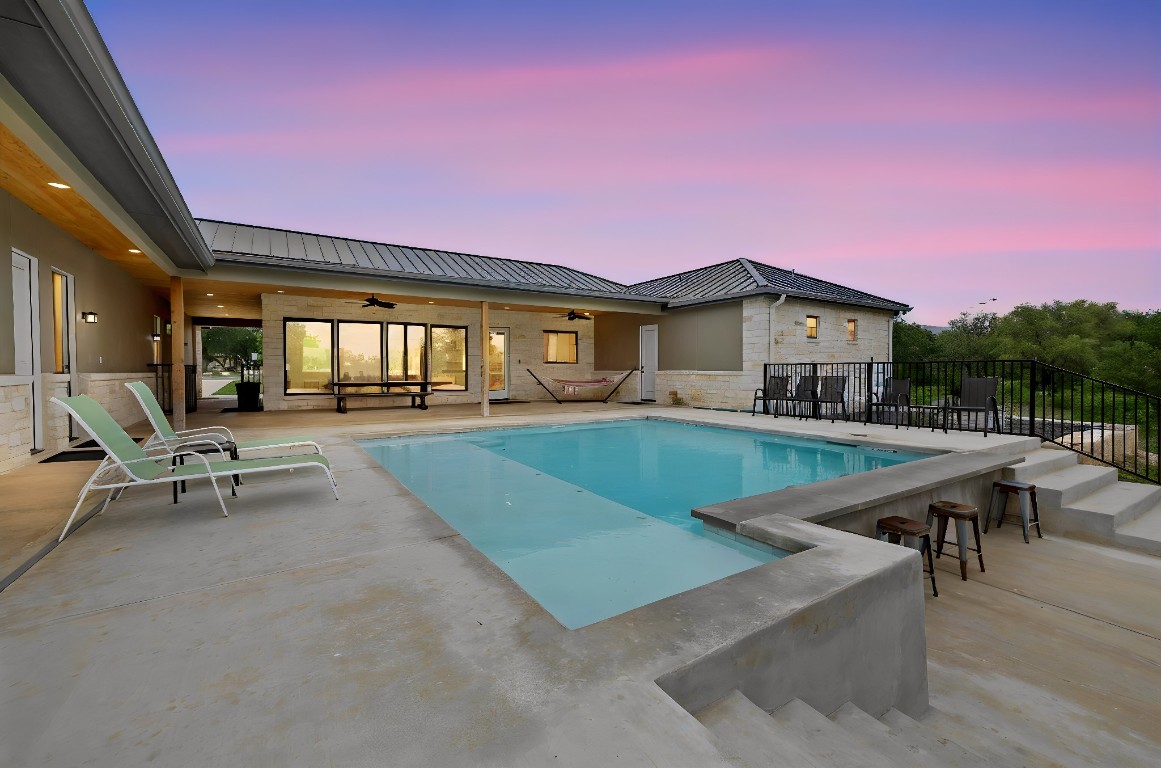 1463 Mountain Valley Road Concan, TX 78838 - Photo 34 of 43 a view of a house with swimming pool and sitting area