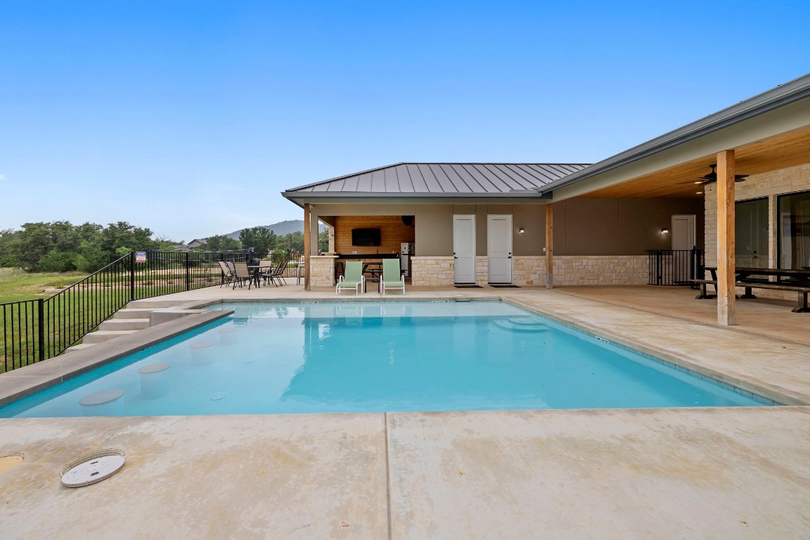 1463 Mountain Valley Road Concan, TX 78838 - Photo 35 of 43 a view of a house with pool and chairs