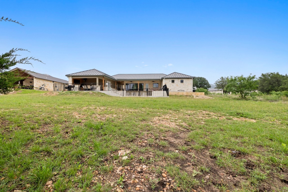 1463 Mountain Valley Road Concan, TX 78838 - Photo 37 of 43 a front view of a house with a garden
