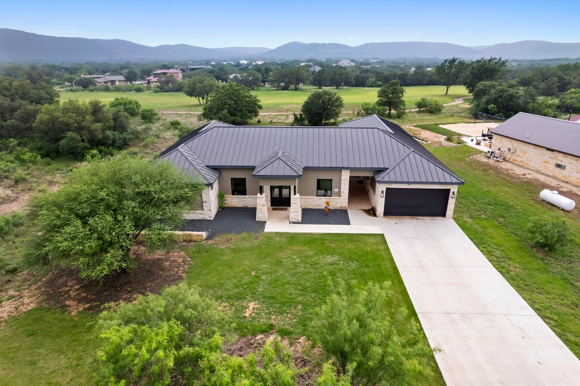 1463 Mountain Valley Road Concan, TX 78838 - Photo 41 of 43 a front view of a house with a yard and mountain