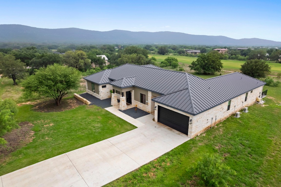 1463 Mountain Valley Road Concan, TX 78838 - Photo 42 of 43 a aerial view of a house with a yard and mountain