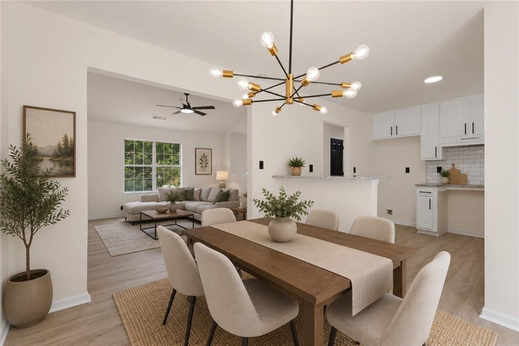 3602 Bristol Overlook Rex, GA 30273 - Photo 12 of 37 a dining room with furniture a chandelier and wooden floor