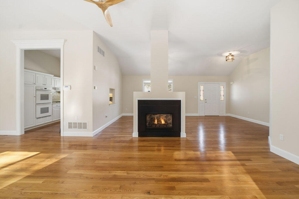 240 Surf Drive Mashpee, MA 02649 - Photo 14 of 45 Central gas fireplace to dining room