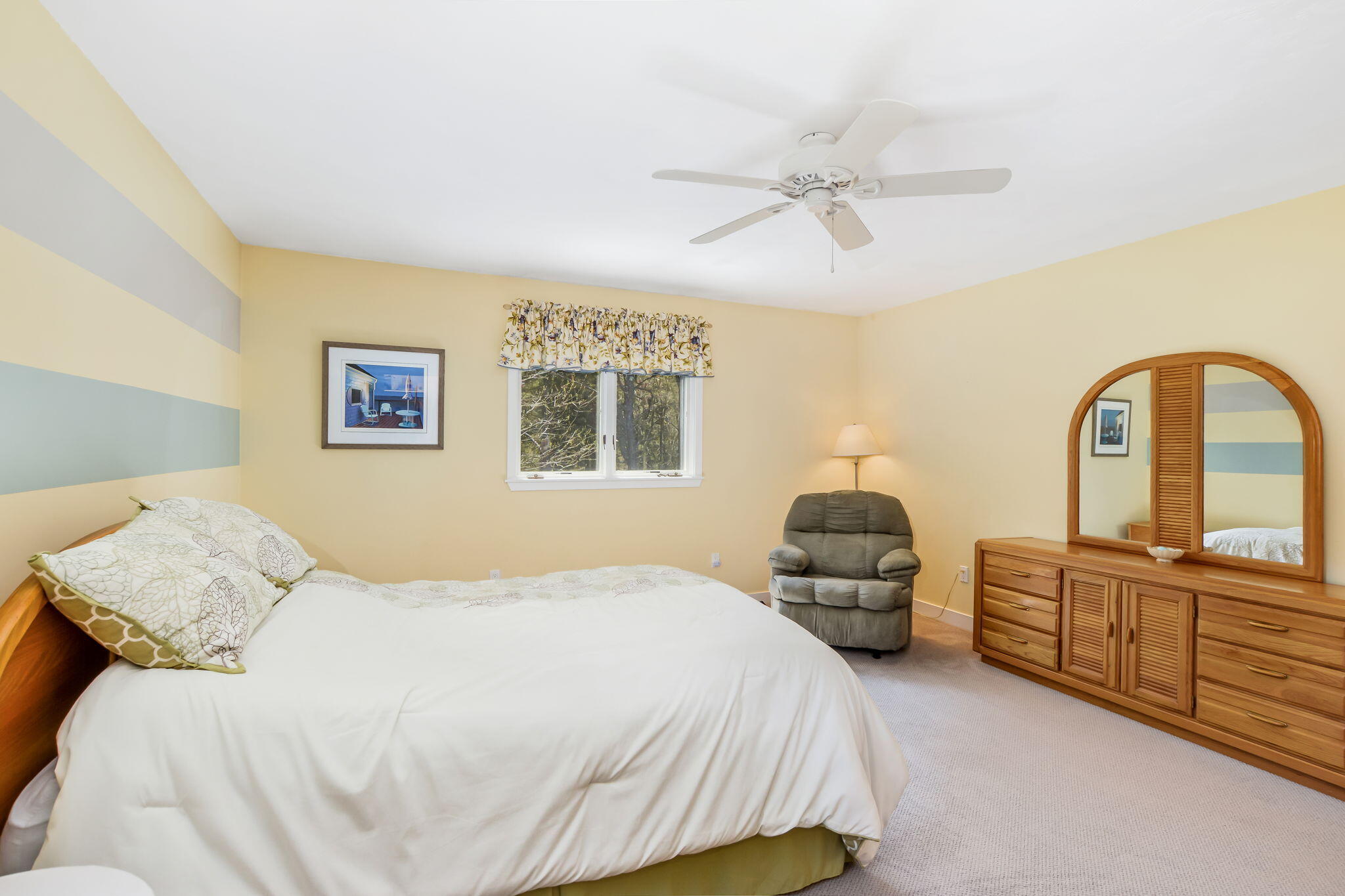 240 Surf Drive Mashpee, MA 02649 - Photo 16 of 37 a bedroom with a bed and dresser with mirror