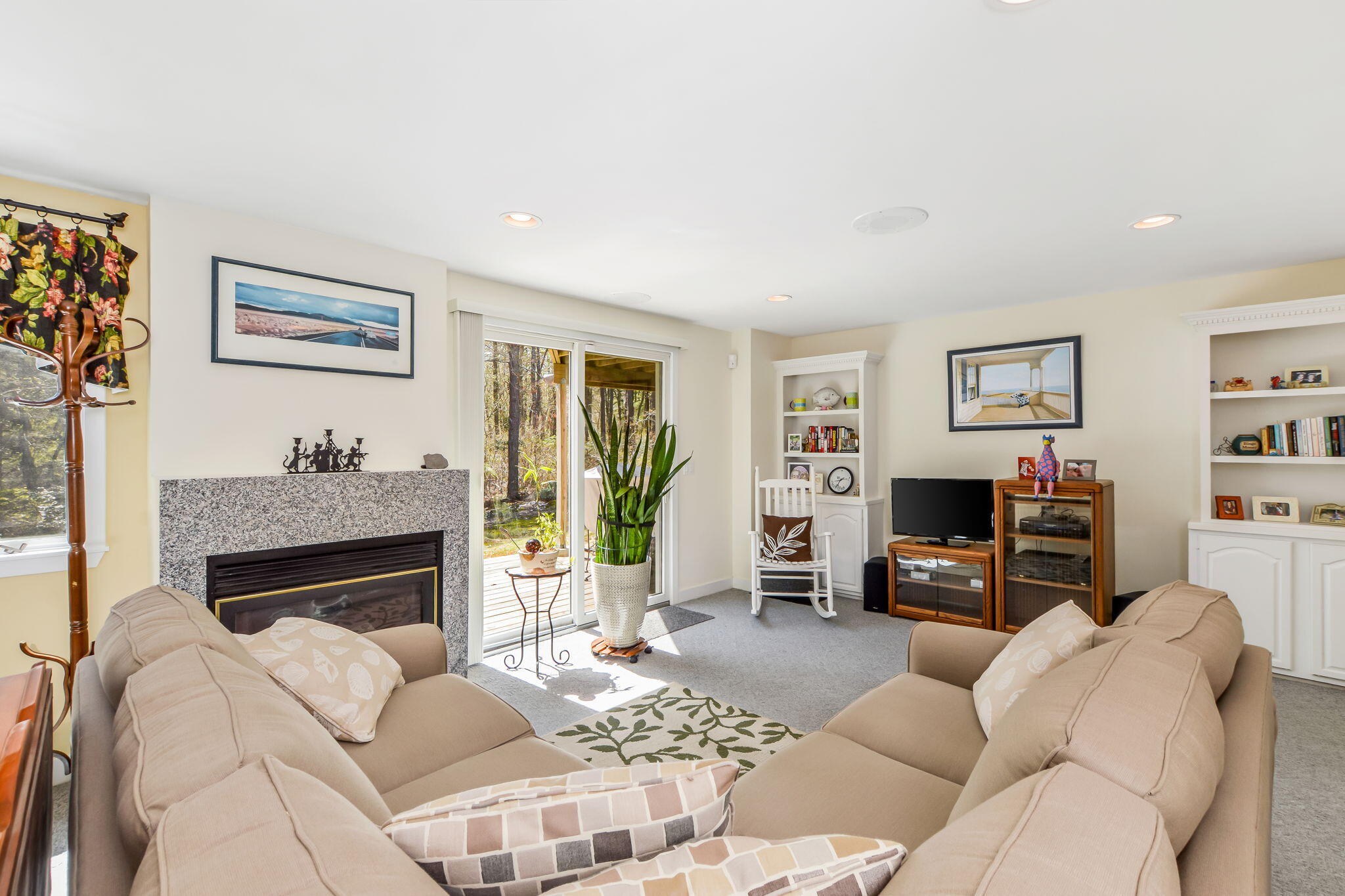 240 Surf Drive Mashpee, MA 02649 - Photo 19 of 37 a living room with furniture a fireplace and a flat screen tv